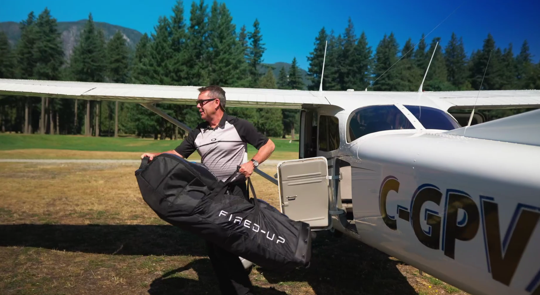 Unloading a golf bag from a small private plane