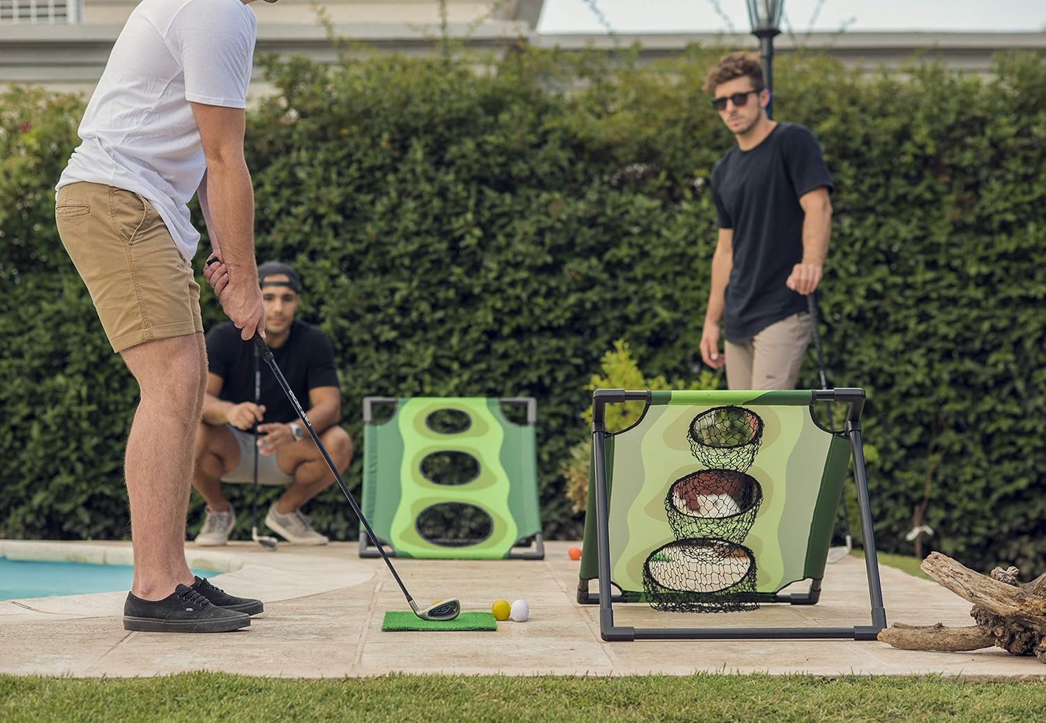 Group of golfers playing the golf version of cornhole game.