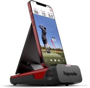 A compact black and red Rapsodo Mobile Launch Monitor with a phone displaying the swing analysis app.