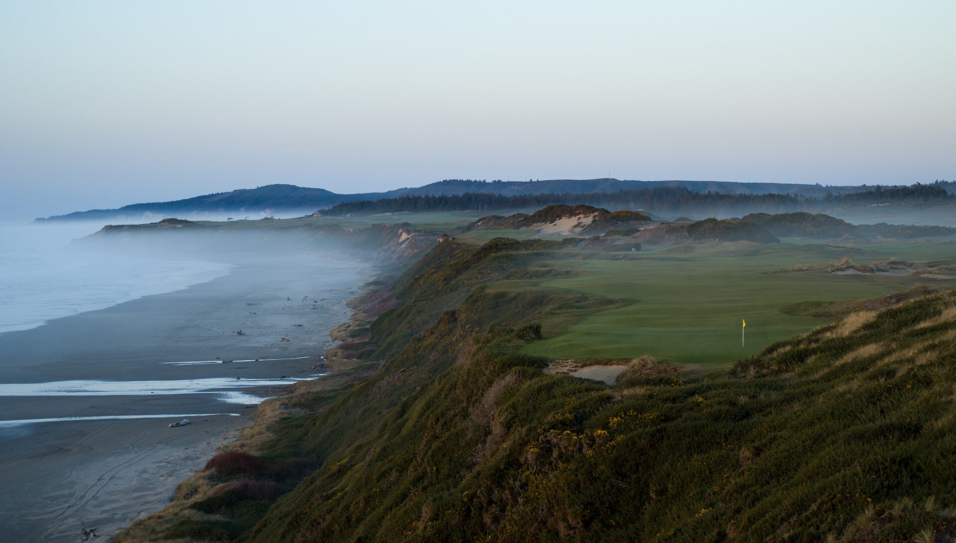 Pacific Dunes fairway with coastal dunes and ocean light at Bandon Dunes