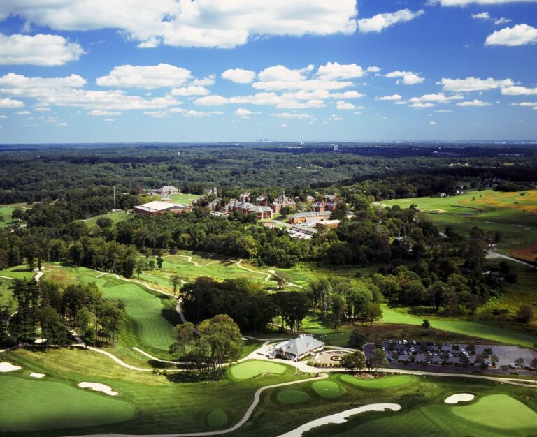 Aerial view of The Golf Course at Glen Mills with the Philadelphia skyline on the horizon