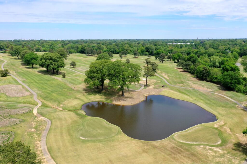 Aerial view of fairways and a pond at Pine Hill Municipal Golf Course in Memphis.