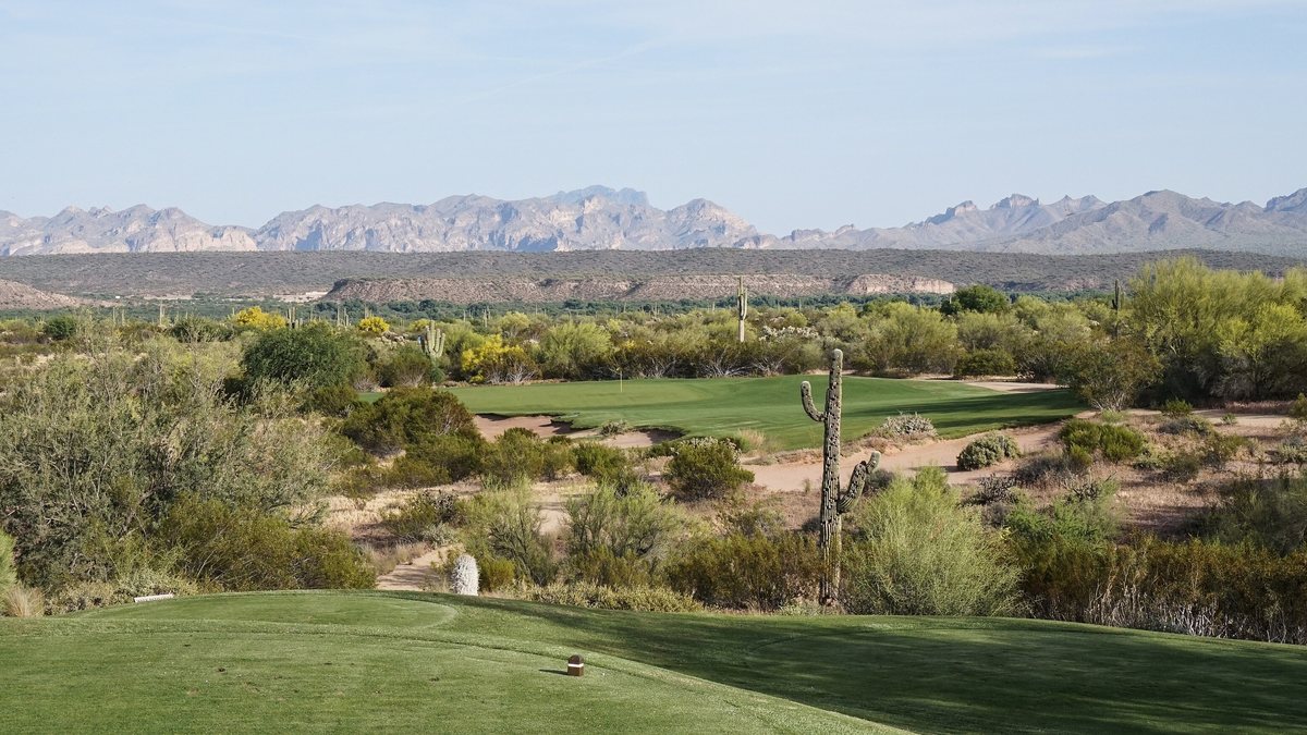 Tee shot over desert scrub to the 15th hole of the Saguaro course at We-Ko-Pa Golf Club, with the McDowell Mountains behind