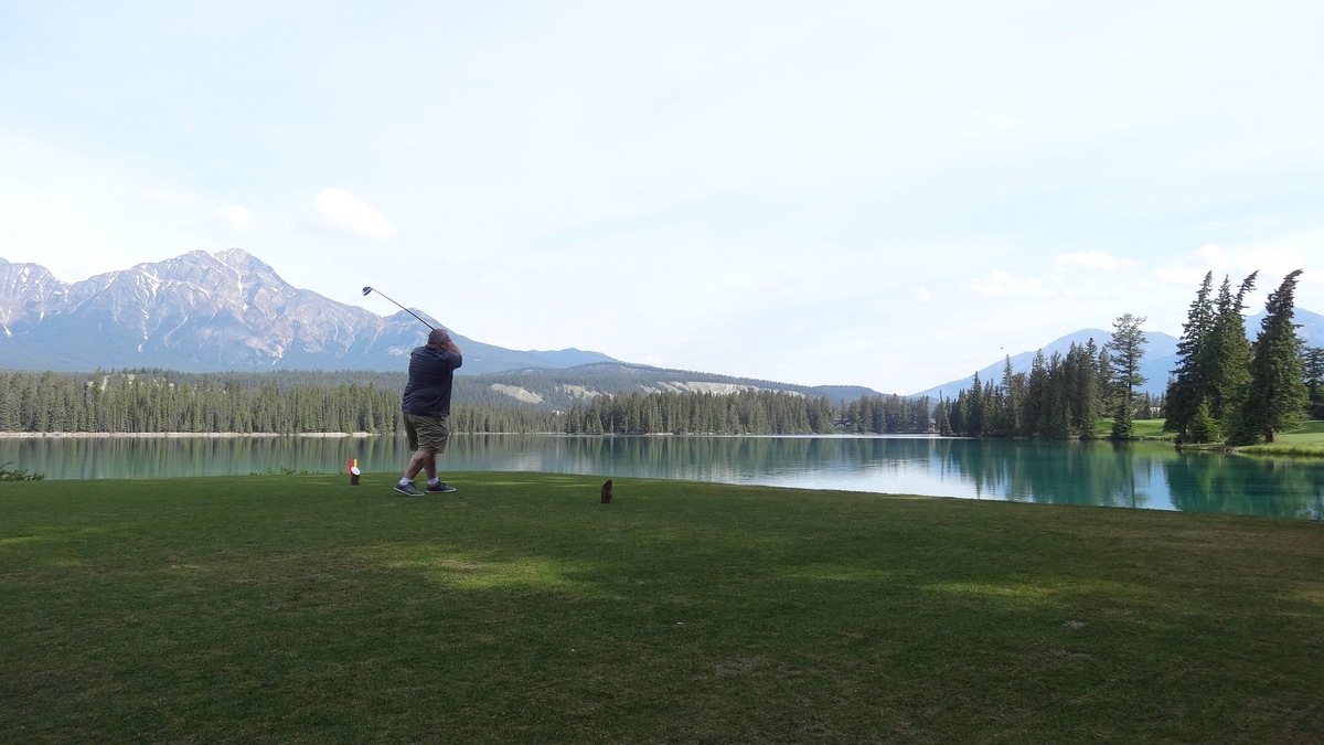 Lakeside hole at the Jasper Park Lodge golf course with mountains behind