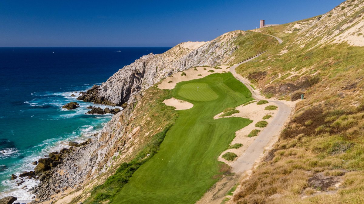Clifftop fairway and green at Quivira Golf Club above the rocky Pacific shoreline in Cabo San Lucas
