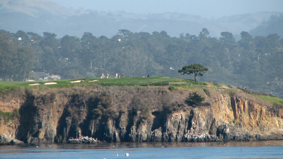 The sixth hole at Pebble Beach Golf Links climbing above the cliffs on Carmel Bay